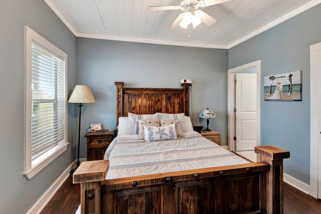 bedroom featuring ceiling fan, crown molding, dark wood-type flooring, and baseboards