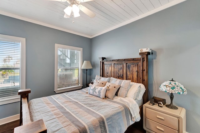 bedroom with a ceiling fan, baseboards, dark wood-style flooring, wood ceiling, and crown molding