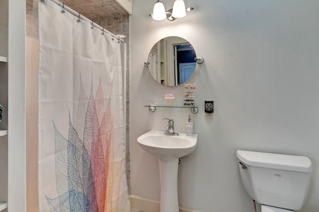 bathroom with a shower with curtain and toilet