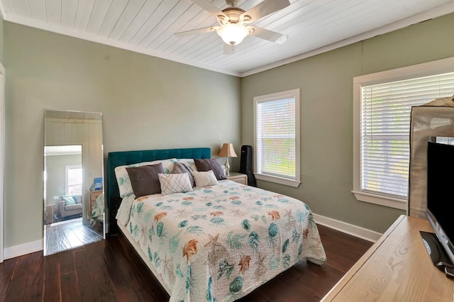 bedroom with multiple windows, baseboards, and dark wood-style flooring