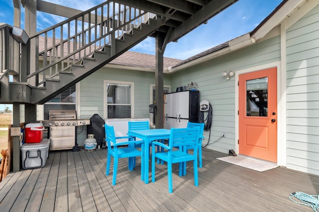 wooden terrace with area for grilling and stairs