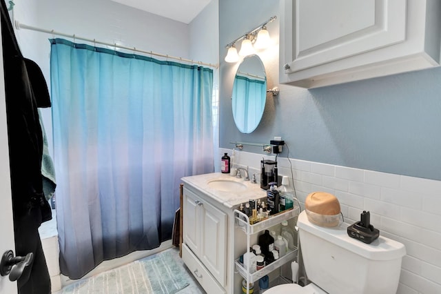 11 Enchanted Ln, Port Alto, TX 77979 - bathroom with vanity, tile walls, a shower with curtain, and wainscoting
