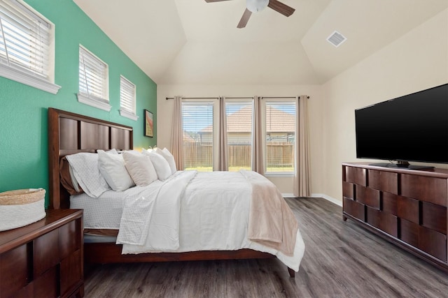 bedroom featuring wood finished floors, baseboards, visible vents, ceiling fan, and vaulted ceiling