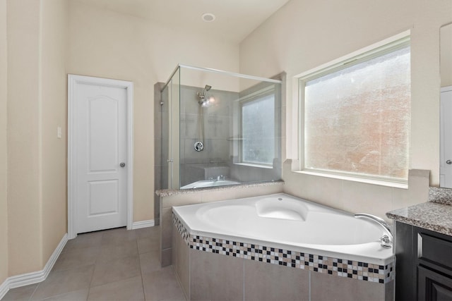 full bathroom with vanity, a shower stall, a garden tub, and tile patterned flooring