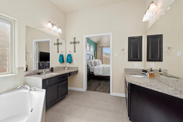 bathroom featuring tile patterned floors, connected bathroom, two vanities, and a sink