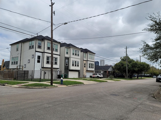 view of front facade featuring a residential view and fence