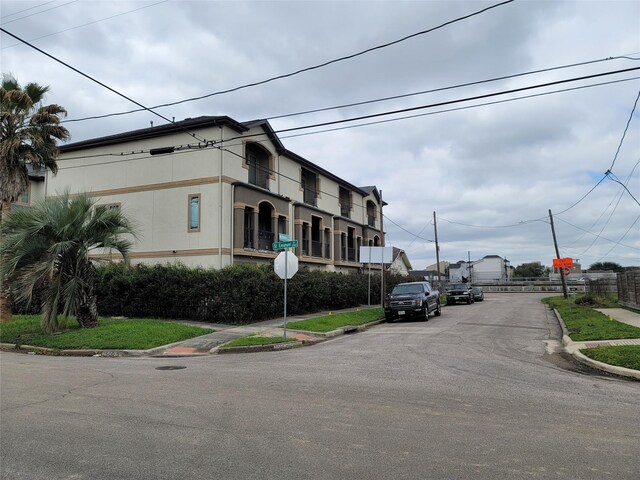 view of street featuring traffic signs, curbs, and sidewalks