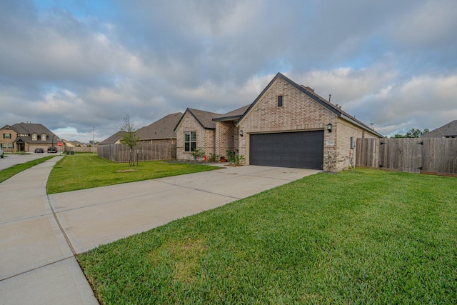 view of front facade featuring a front yard, fence, an attached garage, concrete driveway, and brick siding