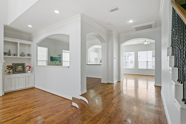 interior space featuring recessed lighting, visible vents, ornamental molding, and wood finished floors