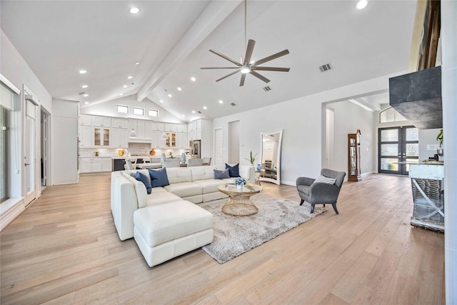 living area featuring visible vents, beam ceiling, high vaulted ceiling, french doors, and light wood-style floors