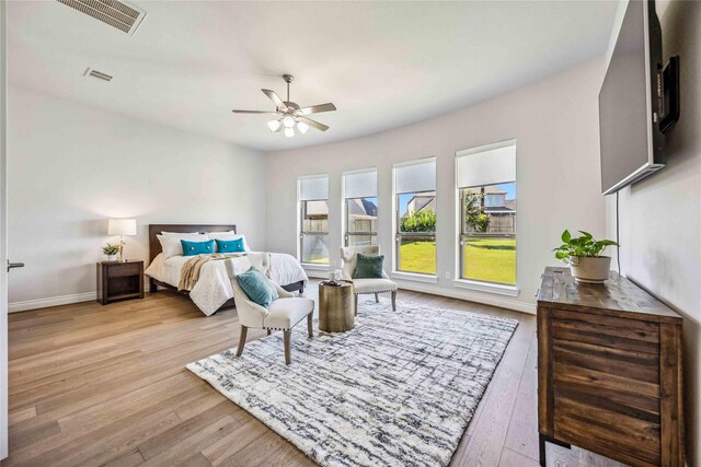 bedroom featuring visible vents, baseboards, and wood finished floors