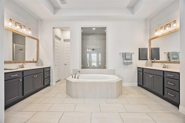 full bathroom with a shower stall, two vanities, and a sink