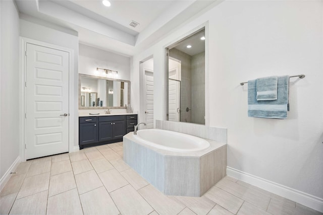 full bathroom with vanity, baseboards, visible vents, tiled shower, and a bath