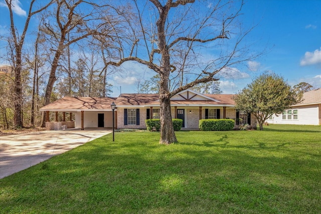 ranch-style house featuring a carport, driveway, brick siding, and a front lawn