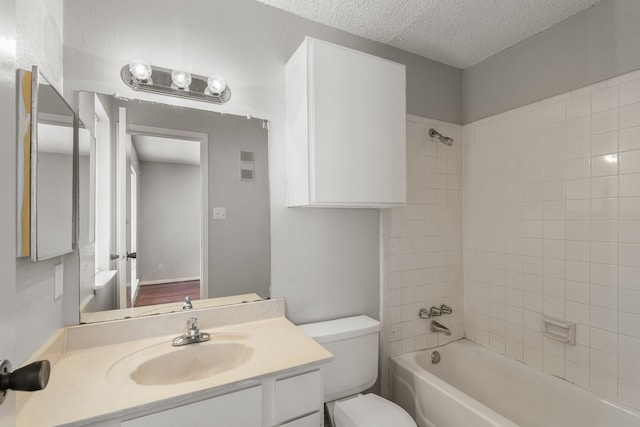 bathroom featuring vanity, visible vents,  shower combination, a textured ceiling, and toilet