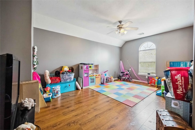 game room with hardwood / wood-style floors, lofted ceiling, visible vents, and ceiling fan