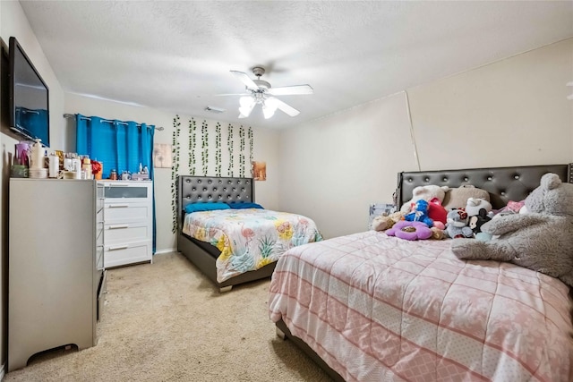 bedroom with carpet flooring, a ceiling fan, visible vents, and a textured ceiling