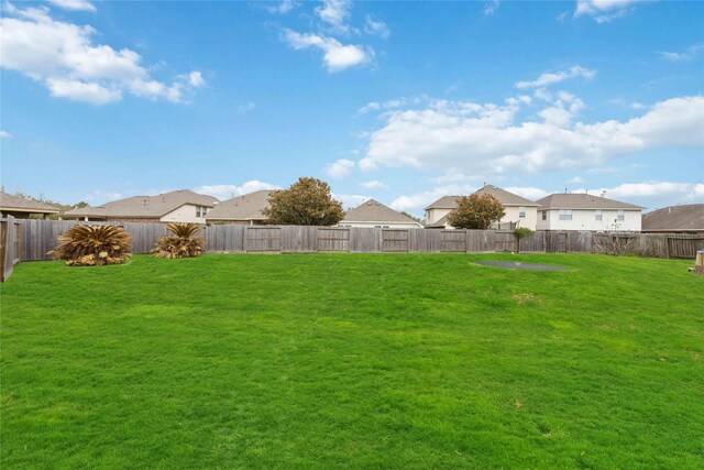 view of yard featuring a residential view and a fenced backyard