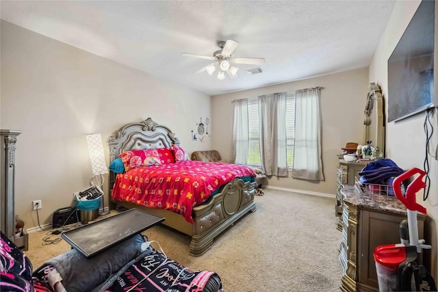 bedroom featuring visible vents, a ceiling fan, baseboards, and carpet floors