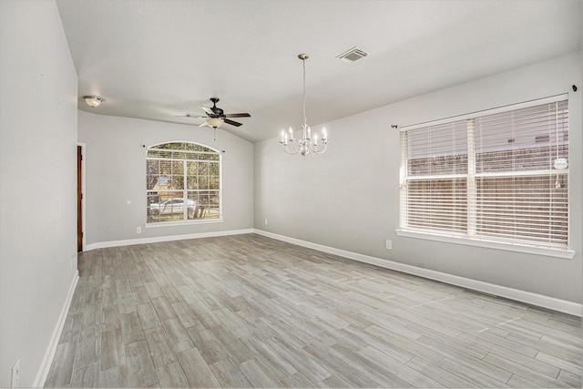 unfurnished room with visible vents, baseboards, light wood-style flooring, vaulted ceiling, and ceiling fan with notable chandelier