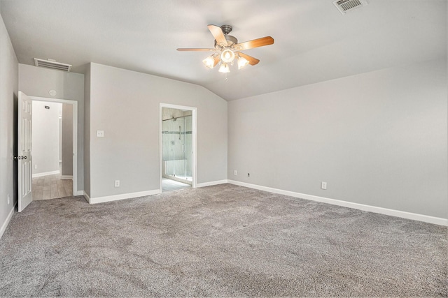 unfurnished bedroom with visible vents, lofted ceiling, baseboards, and carpet flooring