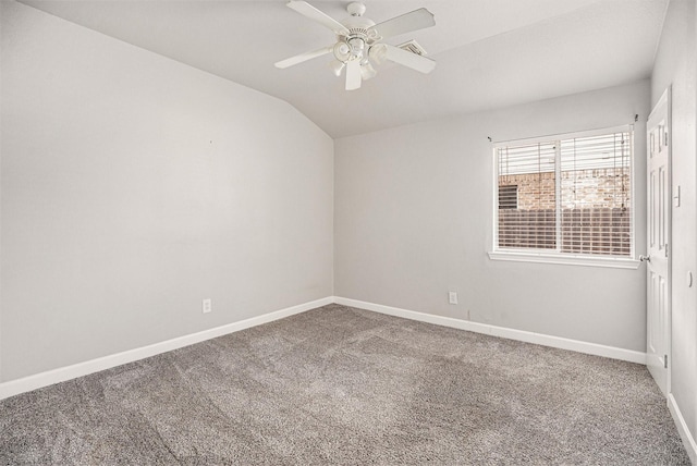 carpeted spare room with baseboards, lofted ceiling, and ceiling fan