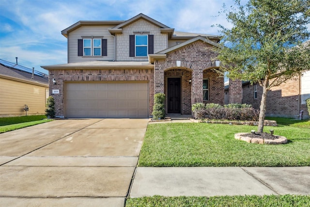 view of front facade featuring brick siding, a garage, driveway, and a front yard