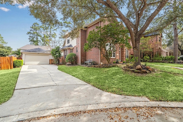 traditional-style house featuring a front yard, fence, concrete driveway, a garage, and brick siding