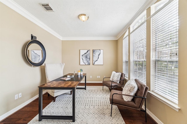 home office with visible vents, ornamental molding, a textured ceiling, wood finished floors, and baseboards