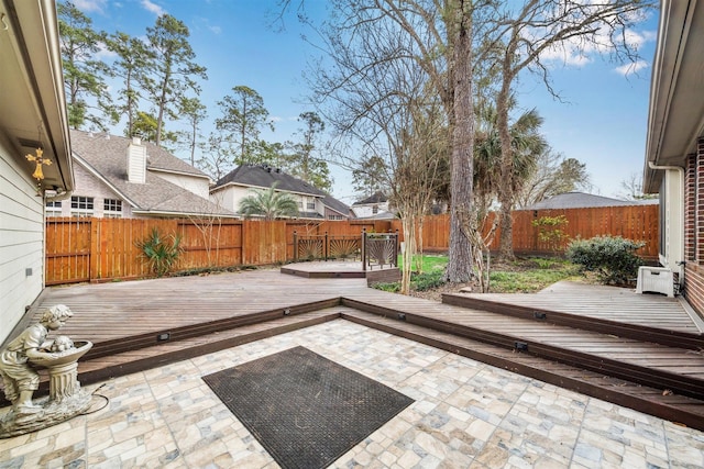 view of patio / terrace with a deck and a fenced backyard