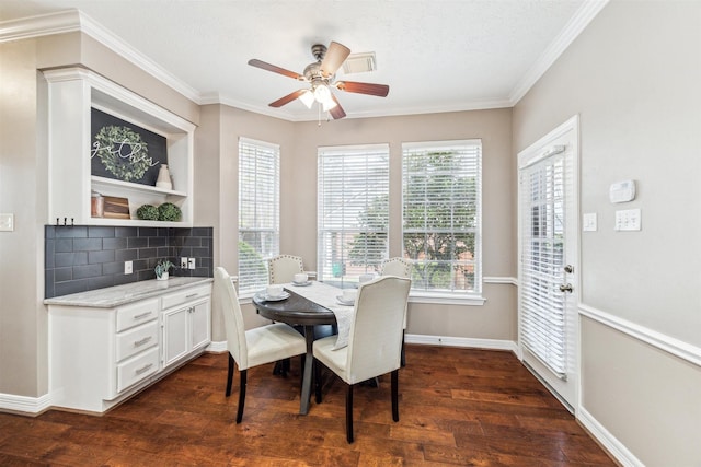 dining room featuring dark wood-style floors, a ceiling fan, crown molding, and baseboards