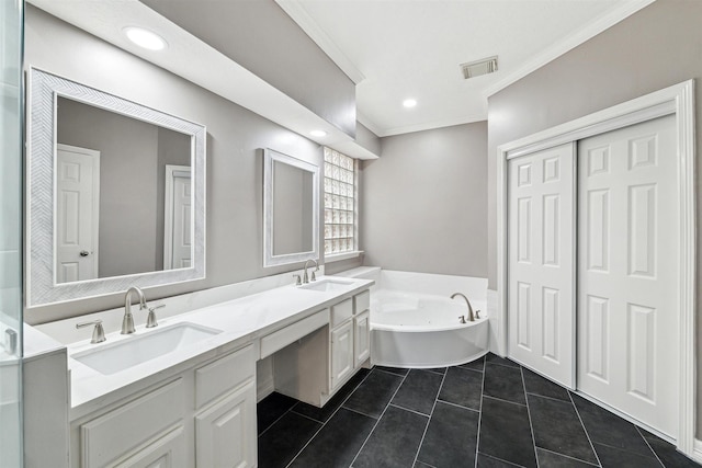 full bathroom featuring tile patterned floors, visible vents, a garden tub, and a sink