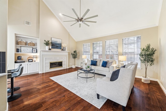 living area featuring visible vents, a fireplace, dark wood-type flooring, and baseboards