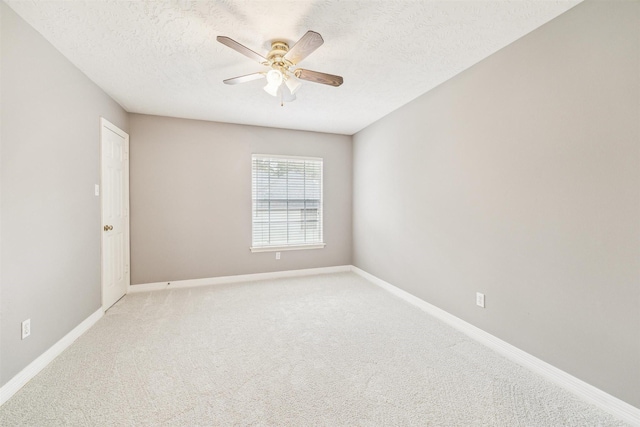 unfurnished room with baseboards, light carpet, a textured ceiling, and ceiling fan