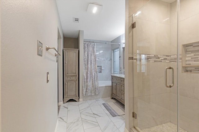 full bath with visible vents, marble finish floor, vanity, and tiled shower / bath