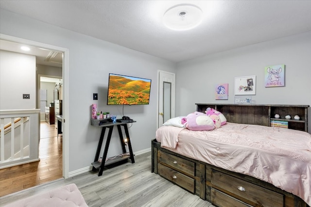 bedroom featuring baseboards and light wood-type flooring