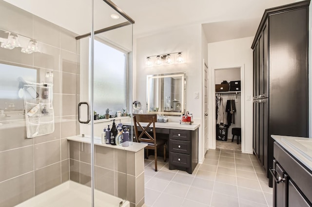 full bath featuring tile patterned floors, a stall shower, and vanity