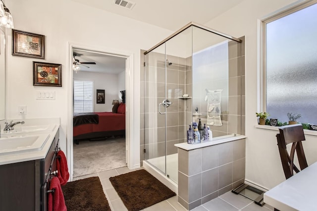 ensuite bathroom featuring a sink, a stall shower, ensuite bathroom, and tile patterned flooring