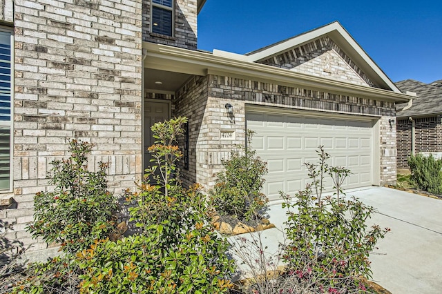 view of side of property featuring an attached garage and driveway