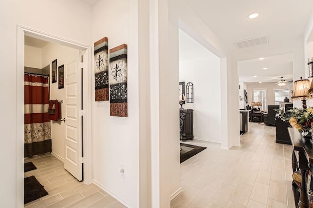 hallway featuring baseboards, recessed lighting, visible vents, and wood tiled floor