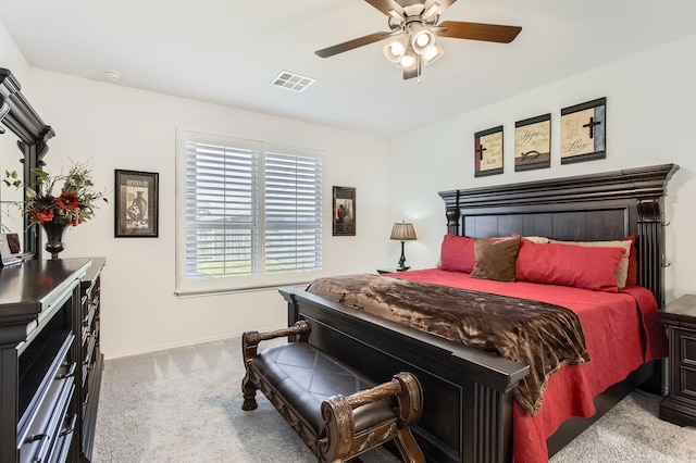 carpeted bedroom with visible vents and a ceiling fan