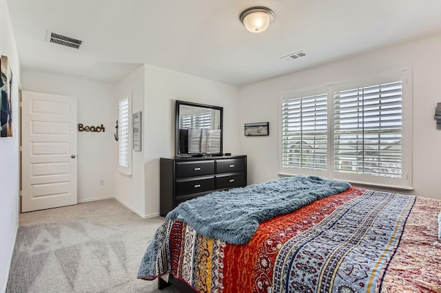 carpeted bedroom with baseboards and visible vents