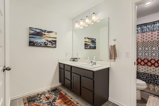 bathroom with tile patterned floors, toilet, vanity, and baseboards