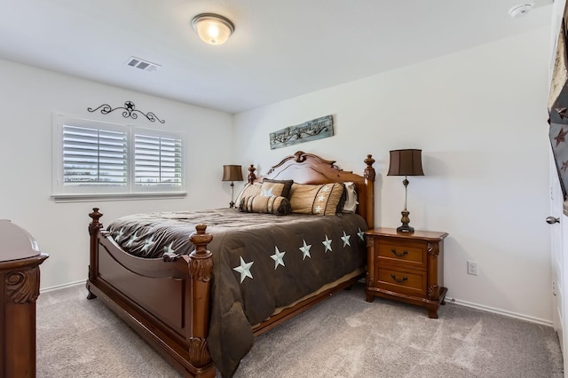 bedroom with light carpet, visible vents, and baseboards