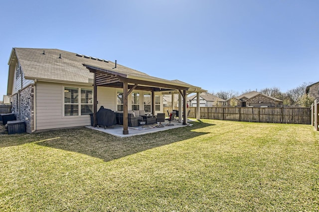 back of house featuring a patio, a lawn, and a fenced backyard