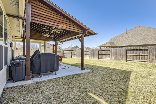 view of yard with a patio area, a fenced backyard, and ceiling fan