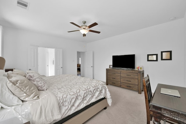 bedroom featuring visible vents, light colored carpet, and ceiling fan