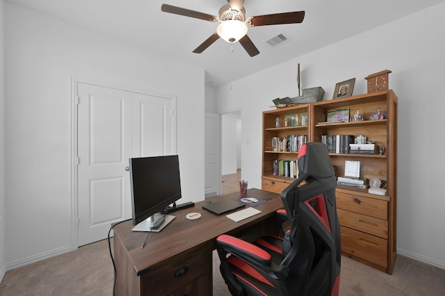 office area with light carpet, visible vents, baseboards, and ceiling fan