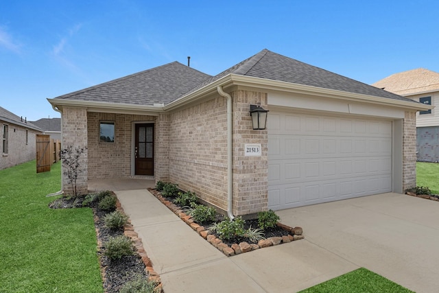 ranch-style house featuring a front yard, brick siding, and roof with shingles