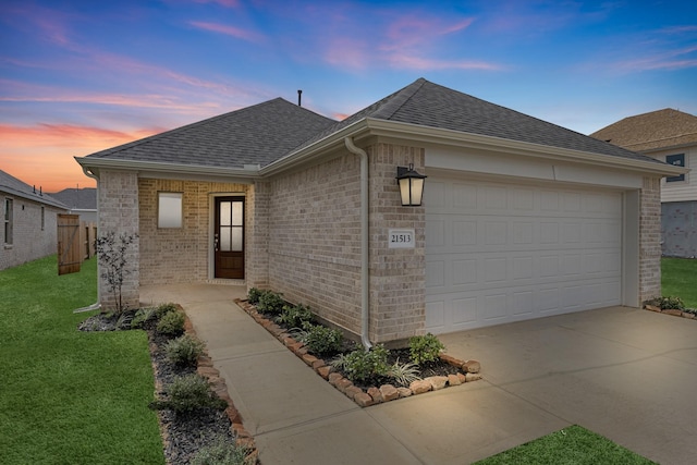 view of front of house featuring brick siding, a front lawn, concrete driveway, roof with shingles, and a garage